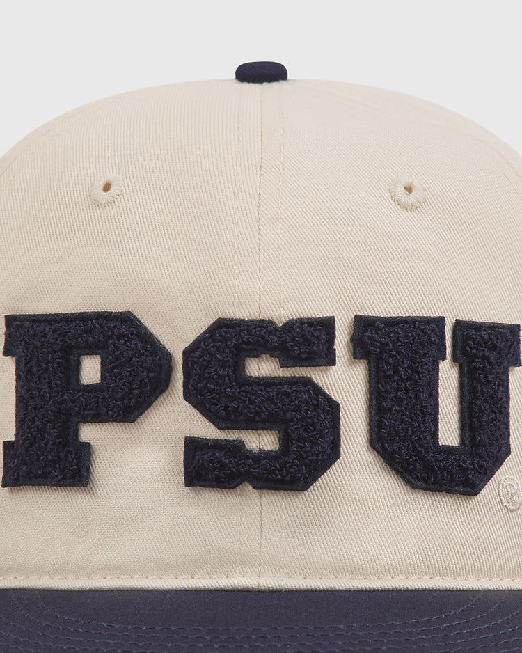 The Ebbets Field Penn State Chenille Logo Cotton Twill Ballcap features a beige cotton twill design with large, dark blue chenille letters spelling out PSU on the front, making it a classic accessory for any fan.