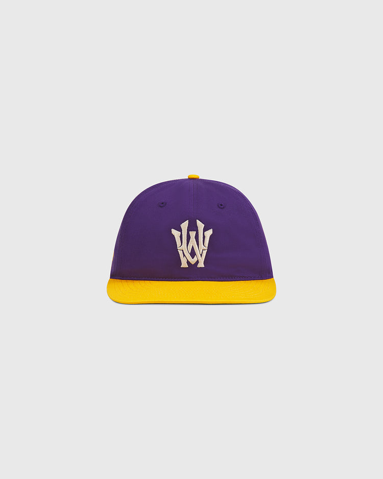 The Ebbets Field University of Washington Cotton Twill Classic Cap features a purple crown with a yellow brim and a white “W” logo on the front, displayed against a plain light gray background.
