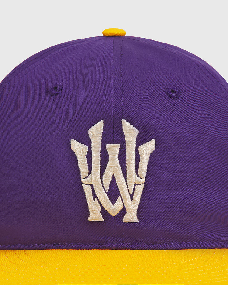 Ebbets Field University of Washington Cotton Twill Classic Cap featuring a purple crown, yellow brim, and a cream-colored embroidered W logo on the front.