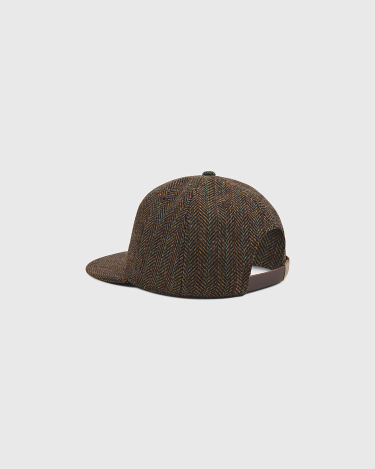 The Harvard University Herringbone Ballcap by Ebbets Field is displayed against a plain light gray background, shown from a rear-side angle with its adjustable strap visible.