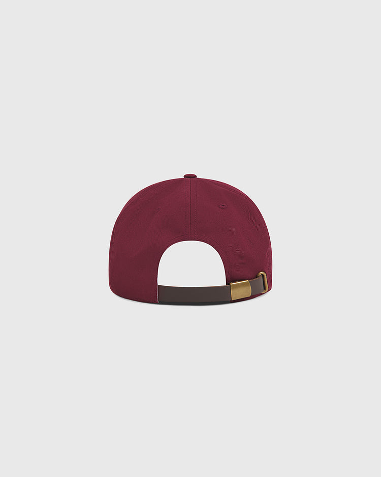 The Harvard University Chenille H Cotton Twill Ballcap by Ebbets Field is shown from the back, highlighting its brown adjustable strap with a metallic buckle, set against a plain light gray background.