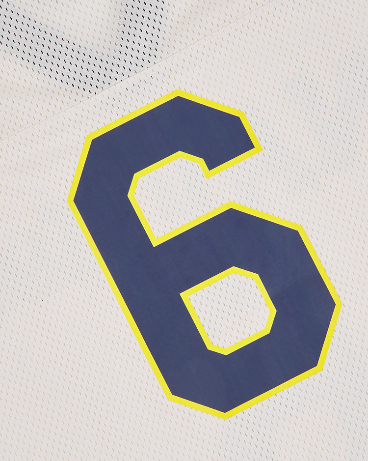 A close-up of the Ebbets Field US Naval Academy Mesh Football Jersey shows a prominent dark blue number 6 outlined in yellow on white mesh fabric.