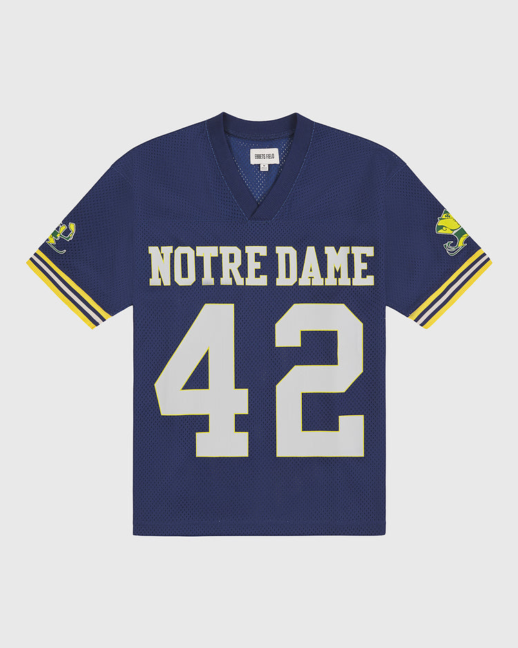 Show your team spirit with the Ebbets Field Notre Dame Mesh Football Jersey—featuring blue mesh fabric, yellow and white sleeve stripes, the number 42 on the front, and a leprechaun mascot on the sleeves—perfect for any Fighting Irish football fan.