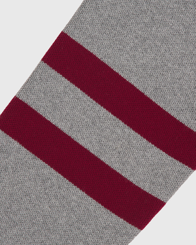A close-up of the Harvard University Cotton Varsity Cardigan by Ebbets Field, featuring soft, knitted gray fabric accented with two thick, horizontal maroon stripes running parallel across it.