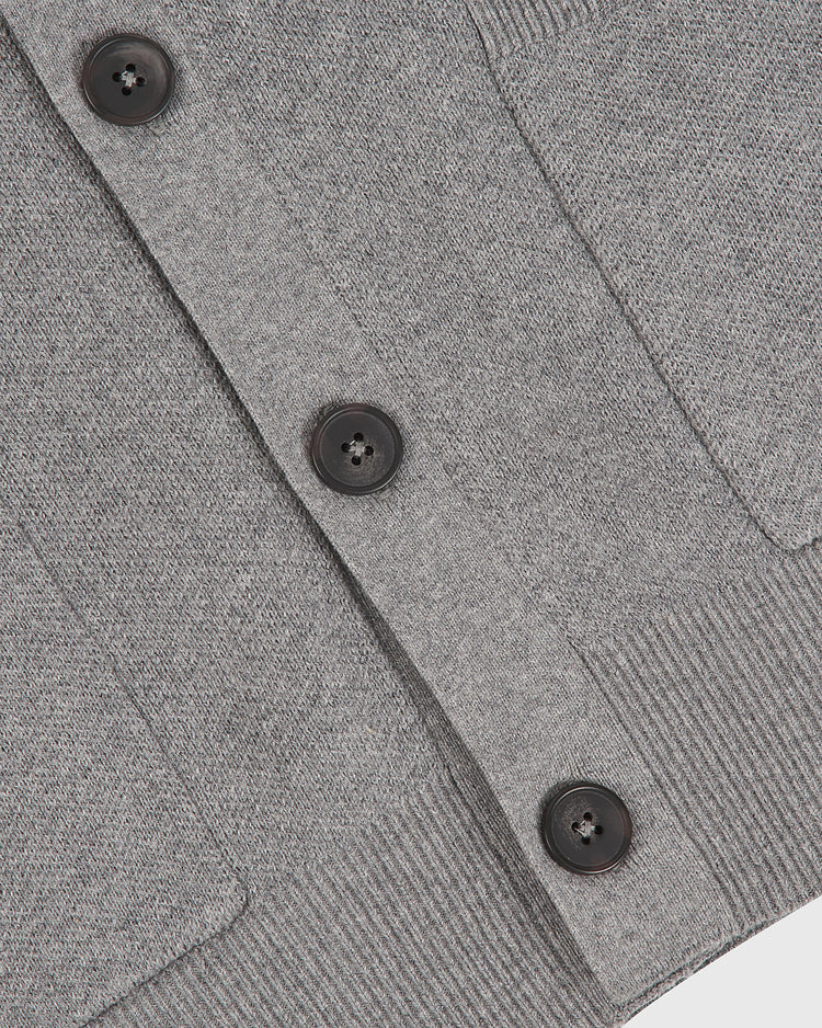 Close-up of the Ebbets Field Harvard University Cotton Varsity Cardigan in gray, featuring three black buttons, a ribbed hem, and visible pocket edges.