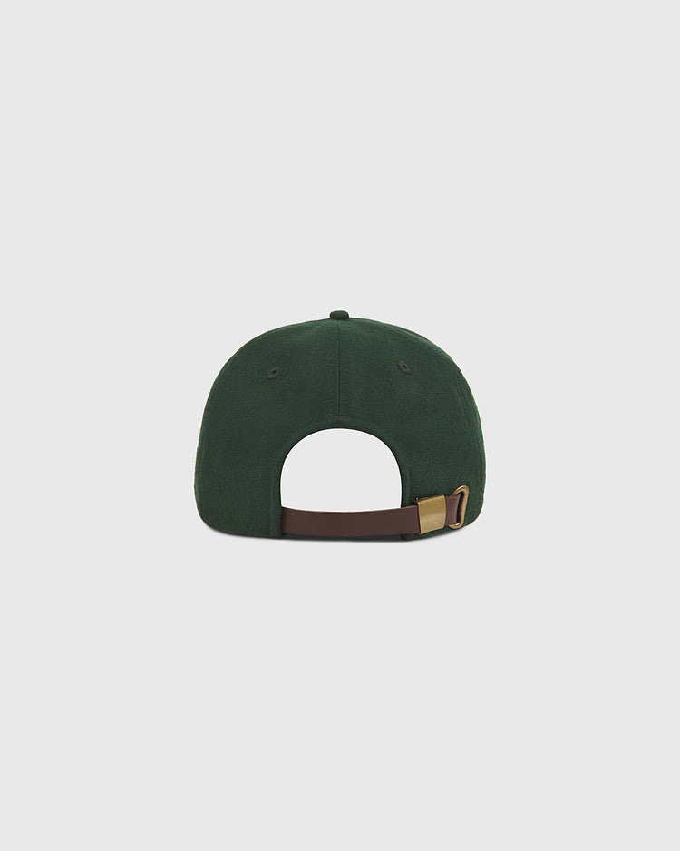 The Ebbets Field Notre Dame X Guinness Wool Ballcap, shown from the back against a plain light gray background, features dark green wool construction and an adjustable brown strap with a brass buckle.