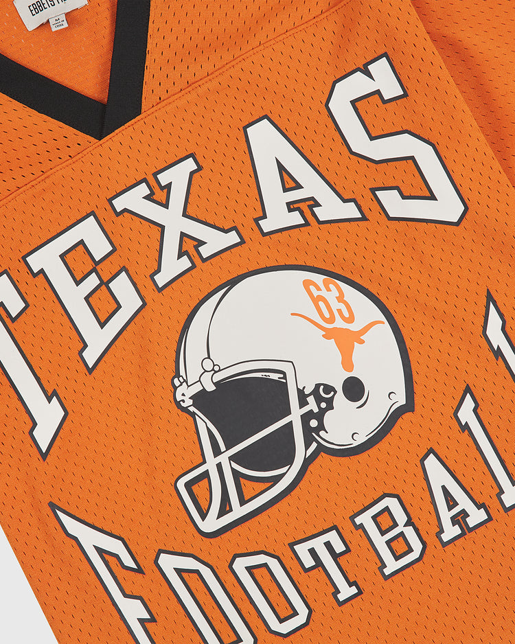 Showcase your Longhorn pride with the Ebbets Field University of Texas Mesh Football Jersey—a bold orange mesh jersey featuring “TEXAS FOOTBALL” in crisp white, a football helmet graphic sporting the iconic Longhorn logo, and the number 63. This vintage-inspired piece is perfect for any University of Texas fan.