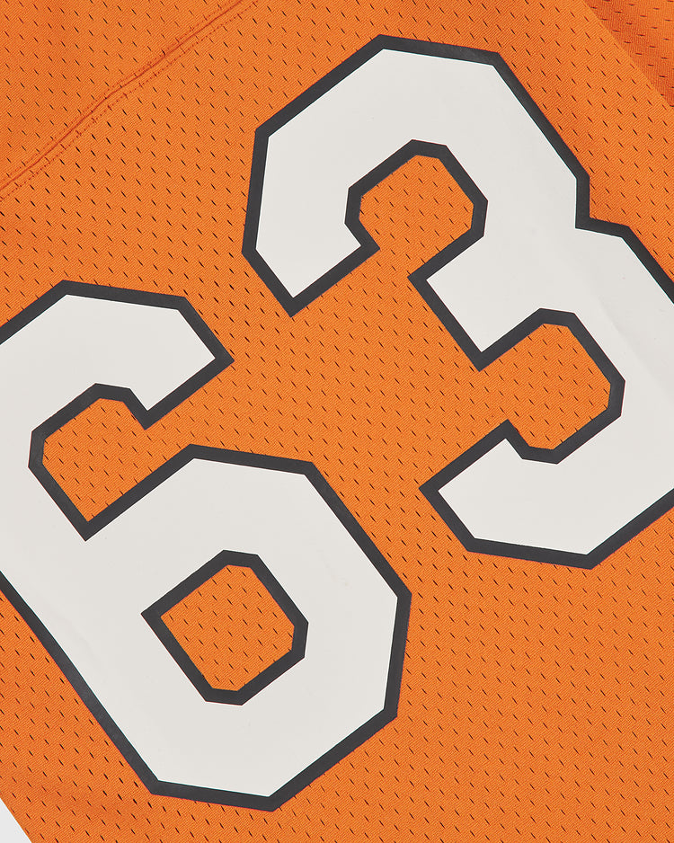 Close-up of the Ebbets Field University of Texas Mesh Football Jersey, featuring large white digits—number 63—outlined in black on bold orange mesh, evoking the style of a classic Longhorn jersey.