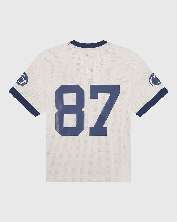 The Ebbets Field Penn State University Mesh Football Jersey features a classic white mesh design with navy blue accents, bold number 87 in large blue font on the back, and a blue lion logo on each sleeve—a timeless look inspired by vintage Penn State jerseys.