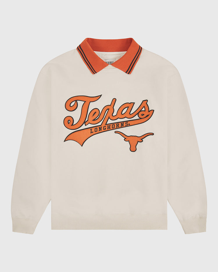The University of Texas Collared Crewneck by Ebbets Field is a cream long-sleeve shirt featuring an orange collar and bold “Texas Longhorns” lettering with a longhorn logo printed in orange on the front.