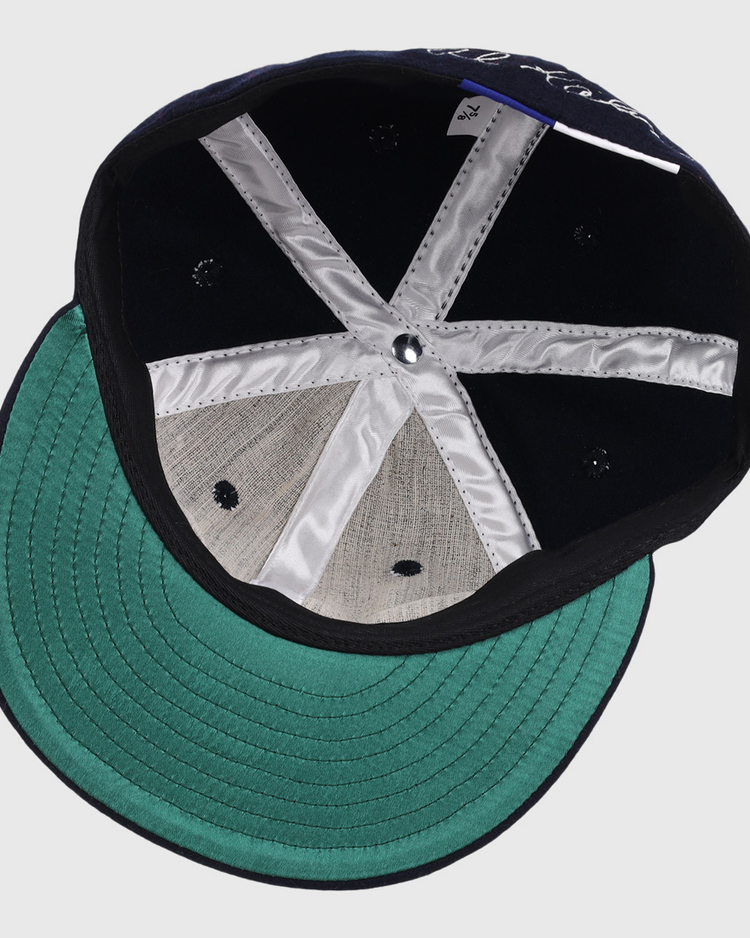 Top-down view of the Al Kaline Signature Series Ballcap by Ebbets Field Flannels, featuring silver inner seams, a green underbrim, and classic black and grey wool—reminiscent of caps in the National Baseball Hall of Fame.