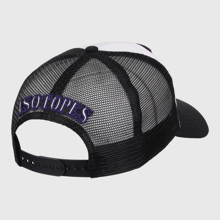 The Ebbets Field Albuquerque Isotopes MiLB Trucker Ballcap features black mesh, white front panels, and “ISOTOPES” embroidered in purple and white above the back opening.