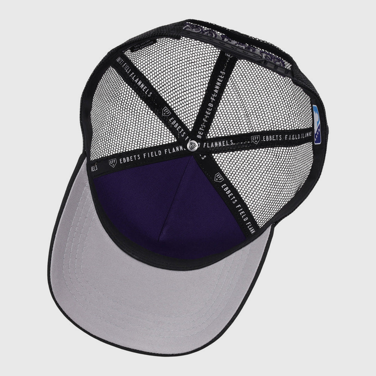 A top-down view of the inside of the Albuquerque Isotopes MiLB Trucker Ballcap by Ebbets Field, featuring a black mesh interior, gray brim, and Ebbets Field branding on the inner black hatbands.