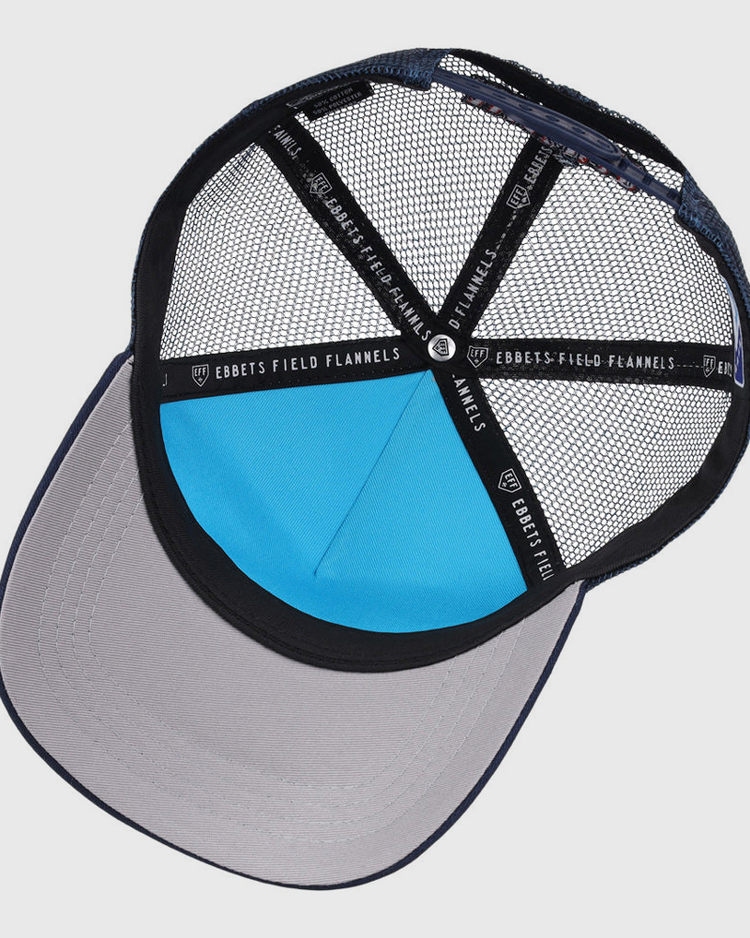 A view of the inside of an Amarillo Sod Poodles MiLB Trucker Ballcap by Ebbets Field, featuring black mesh panels, a light blue front panel, a wide gray brim, and black trim with white 