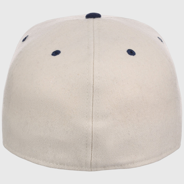The Ebbets Field Atlanta Black Crackers NLB Ballpark Fitted Ballcap is beige, shown from the back with a central seam and four navy blue ventilation holes near the top.