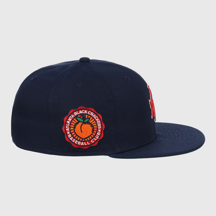 The EFF Atlanta Black Crackers NLB Team Color Fitted Ballcap in navy features a red and orange side patch reading Atlanta Black Crackers Baseball Club around an orange baseball, inspired by classic Negro Southern League styles.