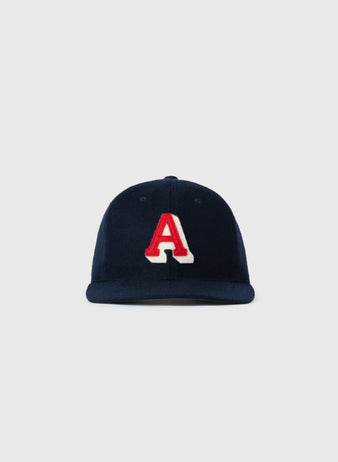 The EFF Atlanta Crackers 1939 Authentic Wool Ballcap features a navy blue design with a bold, red letter A outlined in white on the front, inspired by vintage baseball caps, shown against a plain light gray background.