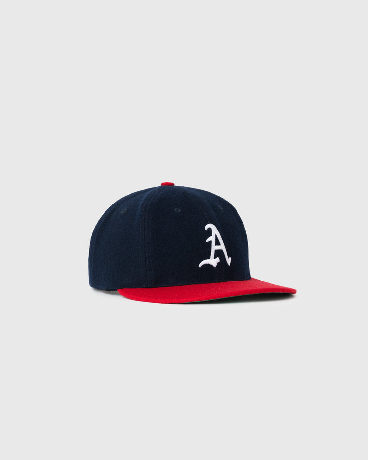 The EFF Atlanta Crackers 1956 Authentic Wool Ballcap features navy wool, a red brim, and a white A on the front, shown on a plain light gray background.