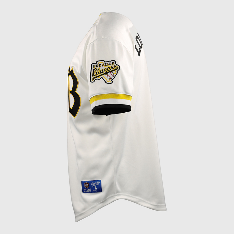 Side view of the EFF Beeville Blazers EFF Lone Star Baseball Jersey in white with black and yellow trim, featuring a Beeville Blazers patch on the sleeve, LOUD lettering on the upper arm, and a partially visible black front number.