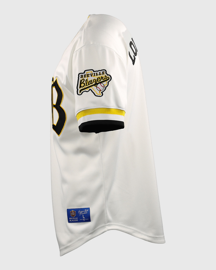 Side view of the EFF Beeville Blazers EFF Lone Star Baseball Jersey in white with black and yellow trim, featuring a Beeville Blazers patch on the sleeve, LOUD lettering on the upper arm, and a partially visible black front number.