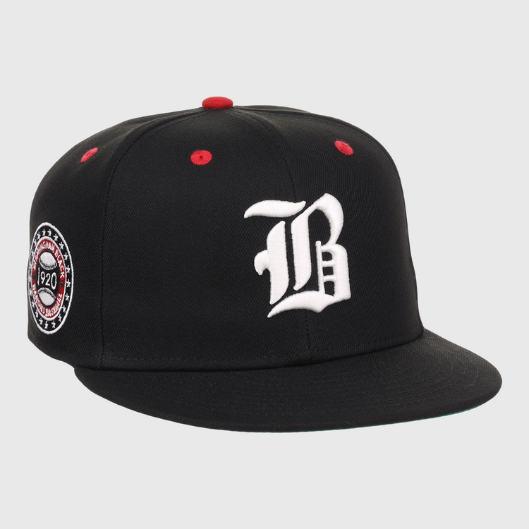 The EFF Birmingham Black Barons NLB Flip Fitted Ballcap is a black cap with a white gothic B, red top button and eyelets, plus a circular patch honoring the Negro National League and Birmingham Black Barons, featuring 1920.