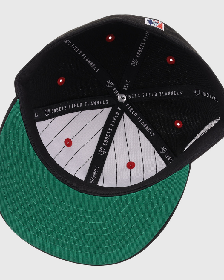 The EFF Birmingham Black Barons NLB Flip Fitted Ballcap features a black exterior, green underbrim, gray pinstriped interior, red button detail, black EBBETS FIELD FLANNELS taping, and honors the Negro National League legacy.