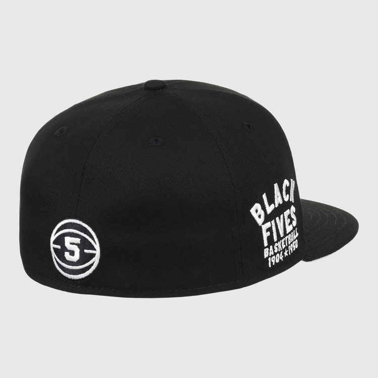 The Black Fives Fitted Ballcap by Ebbets Field Flannels is a black cap with white “BLACK FIVES BASKETBALL 1904-1970s” embroidery on the side and a circular 5 logo on the back, celebrating Black basketball history.