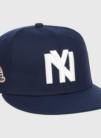 The EFF Brooklyn Eagles NLB Team Color Fitted Ballcap is a navy blue cap with a bold white NY logo on the front and a side eagle patch displaying 1993 and BKLYN EAGLES.