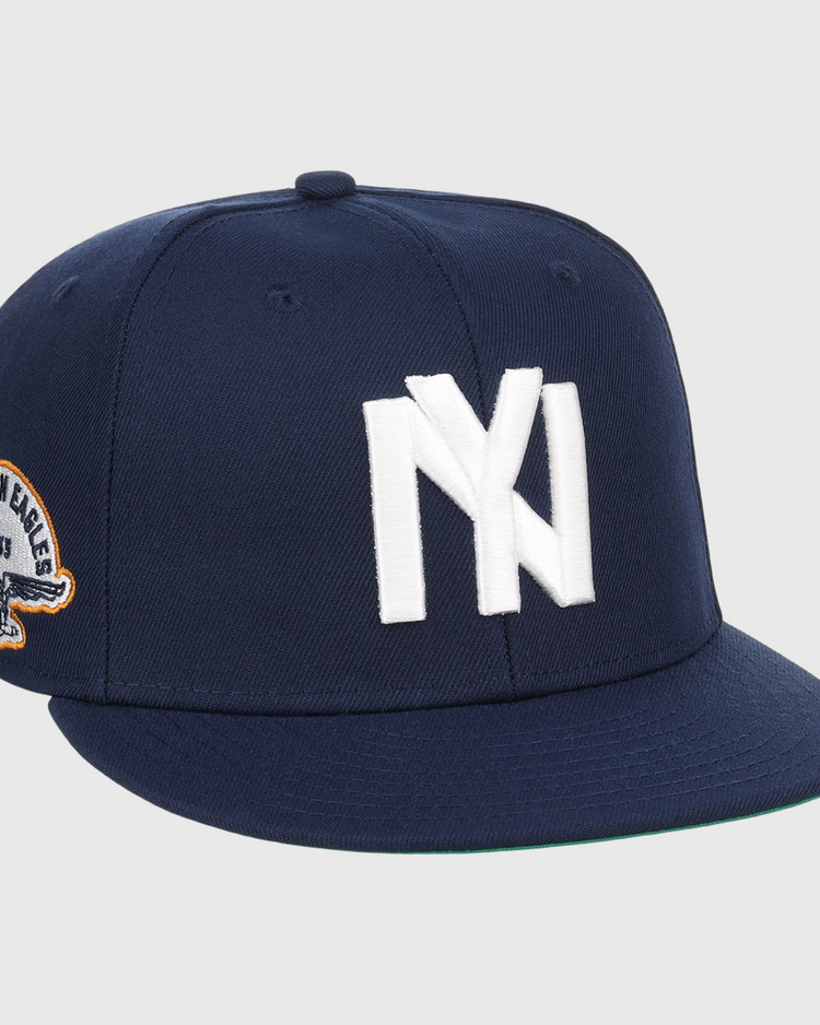 The EFF Brooklyn Eagles NLB Team Color Fitted Ballcap is a navy blue cap with a bold white NY logo on the front and a side eagle patch displaying 1993 and BKLYN EAGLES.