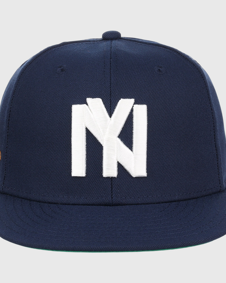 The EFF Brooklyn Eagles NLB Team Color Fitted Ballcap is a navy cap with a large white NY logo on the front, a flat brim, and a small patch on the left side.