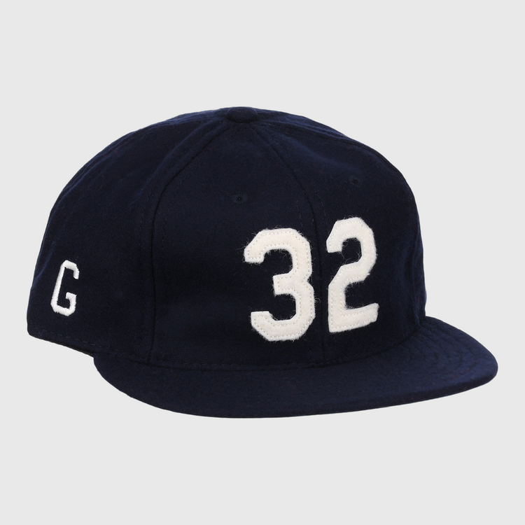 The Buck Leonard Signature Series Ballcap by Ebbets Field Flannels is a vintage navy wool cap with bold white 32 on the front and a white G on the side, honoring Buck Leonard’s legacy in the Negro Leagues.