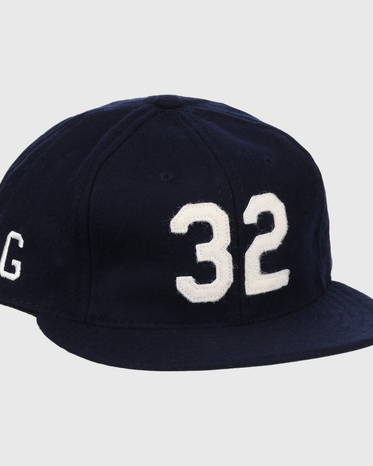 The Buck Leonard Signature Series Ballcap by Ebbets Field Flannels is a vintage navy wool cap with bold white 32 on the front and a white G on the side, honoring Buck Leonard’s legacy in the Negro Leagues.