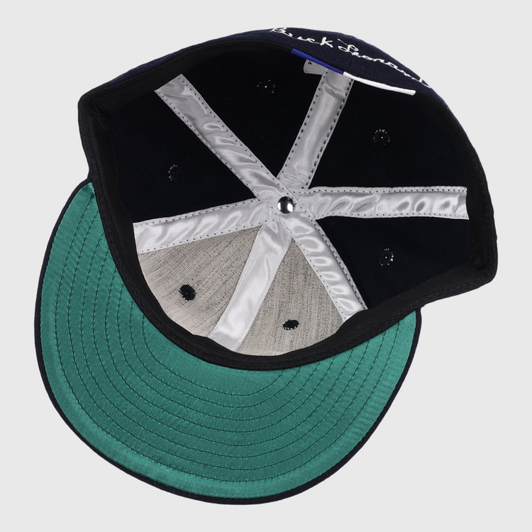 The Buck Leonard Signature Series Ballcap by Ebbets Field Flannels features a green underbrim, silver stitching, black inner panels, a size tag, and vintage details inspired by Negro Leagues legend Buck Leonard.
