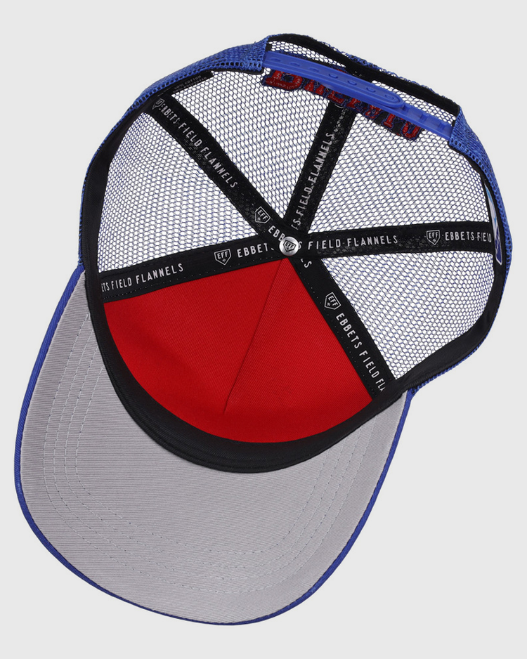 The Buffalo Bisons MiLB Trucker Ballcap by Ebbets Field features a blue crown, grey brim, red front panel, black mesh back, and interior seams lined with Ebbets Field branded tape.