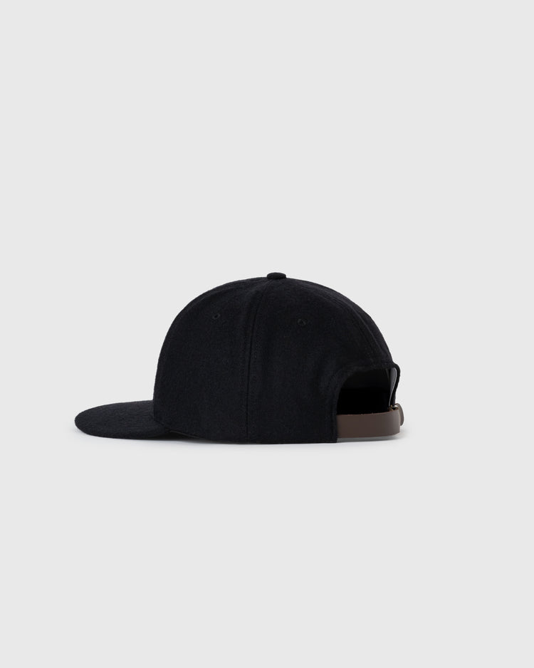 The EFF Fuji Athletic Club 1931 Authentic Wool Ballcap features a black design, curved brim, and an adjustable brown strap at the back. Set against a light gray background, it pays tribute to Japanese-American baseball history.