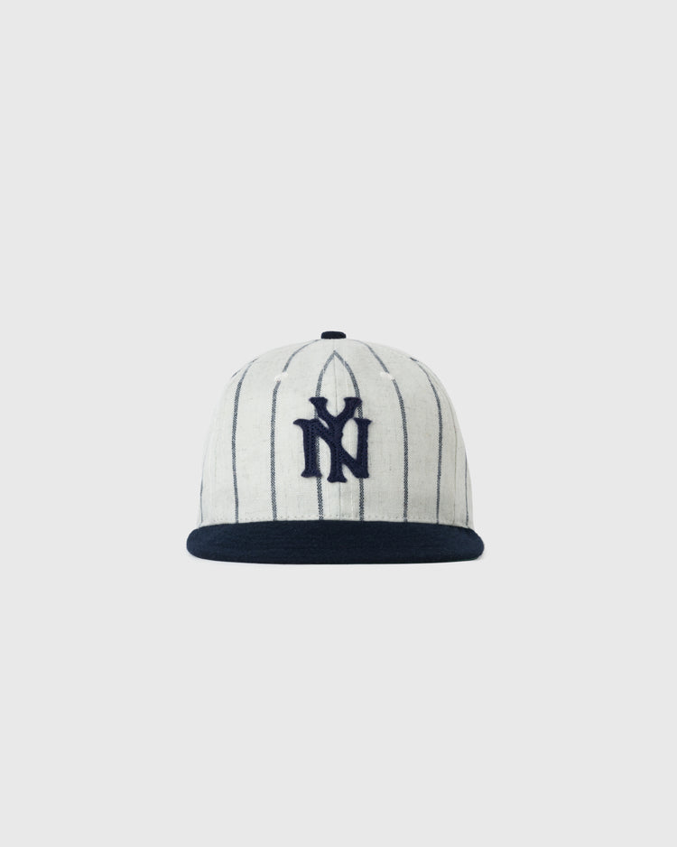 The EFF Bronx Giants 1922 Authentic Wool Soft Short Brim Ballcap is white with thin navy pinstripes, a navy brim, and a large navy NY logo embroidered on the front, shown against a plain white background.