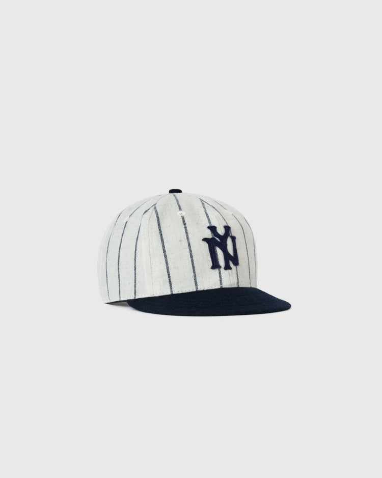 The EFF Bronx Giants 1922 Authentic Wool Soft Short Brim Ballcap features a classic navy NY logo on white with thin vertical navy stripes and a navy brim—ideal for fans of vintage baseball style.