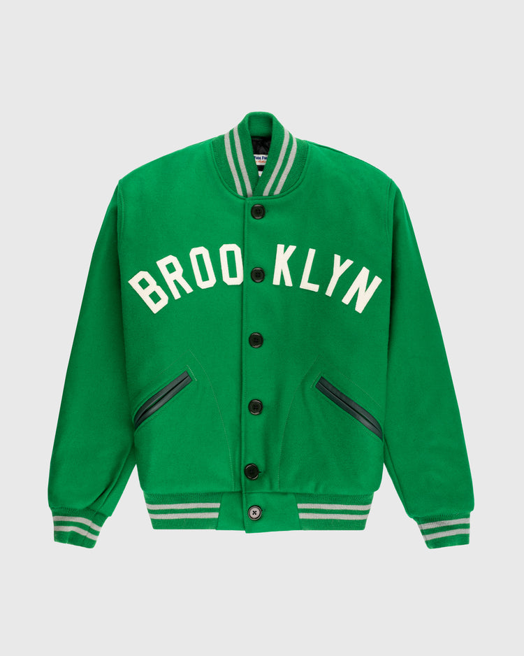The EFF Brooklyn Dodgers 1937 Authentic All Wool Varsity Jacket is a green varsity jacket with white striped trim, BROOKLYN in white across the chest, and two diagonal zippered pockets inspired by an Ebbets Field classic.