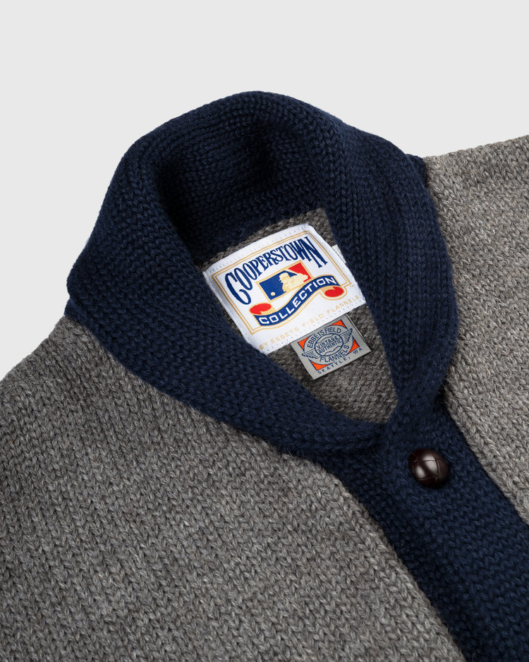 Close-up of the EFF Brooklyn Robins (Dodgers) 1916 Wool Shawl Collar Sweater in gray and navy, featuring a Cooperstown Collection label and vintage-style tag sewn inside the collar.