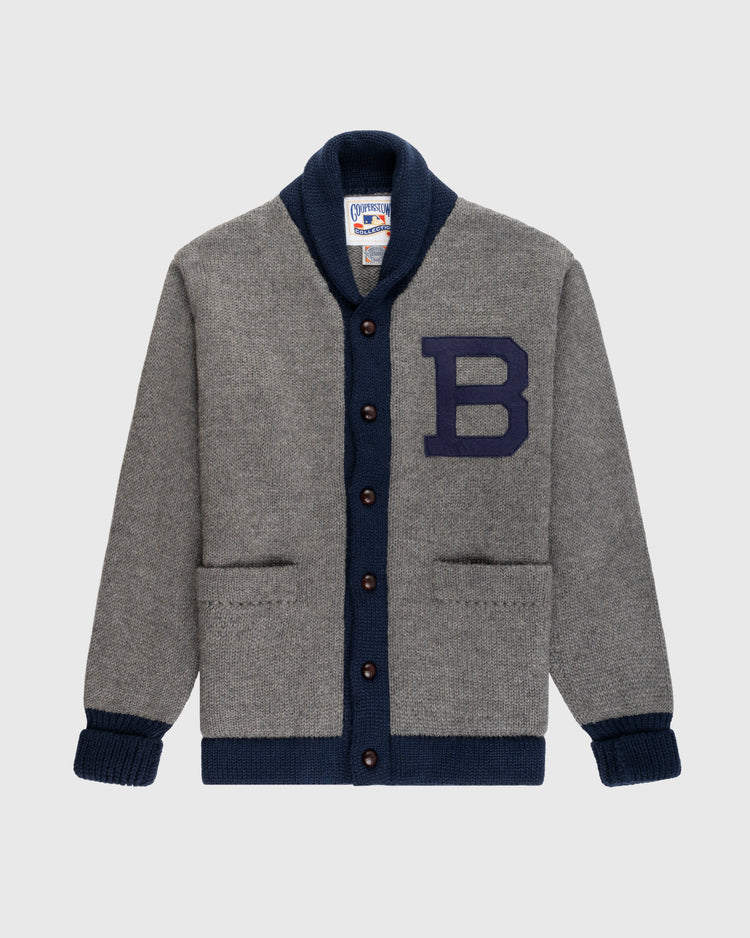 The EFF Brooklyn Robins (Dodgers) 1916 Wool Shawl Collar Sweater is a grey varsity cardigan with navy trim, navy buttons, a large navy B patch, two front pockets, and a classic shawl collar inspired by vintage baseball style.