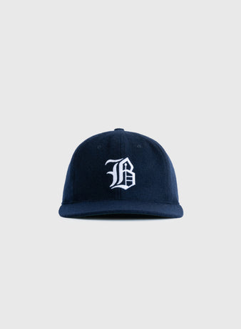 The EFF Buffalo Bisons 1959 Authentic Wool Ballcap features a navy blue design with a white embroidered gothic B on the front, inspired by the original 1959 cap and shown against a plain light gray background.