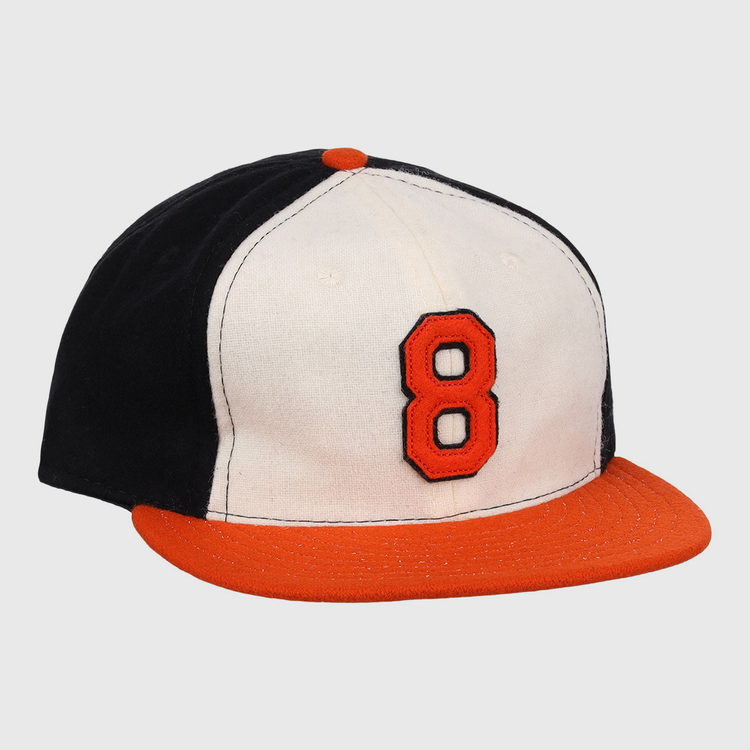 The Ebbets Field Flannels Cal Ripken Jr. Signature Series Ballcap features a vintage design with a black back, white front, orange brim and button, plus a bold orange number 8 outlined in black as tribute to Cal Ripken Jr.