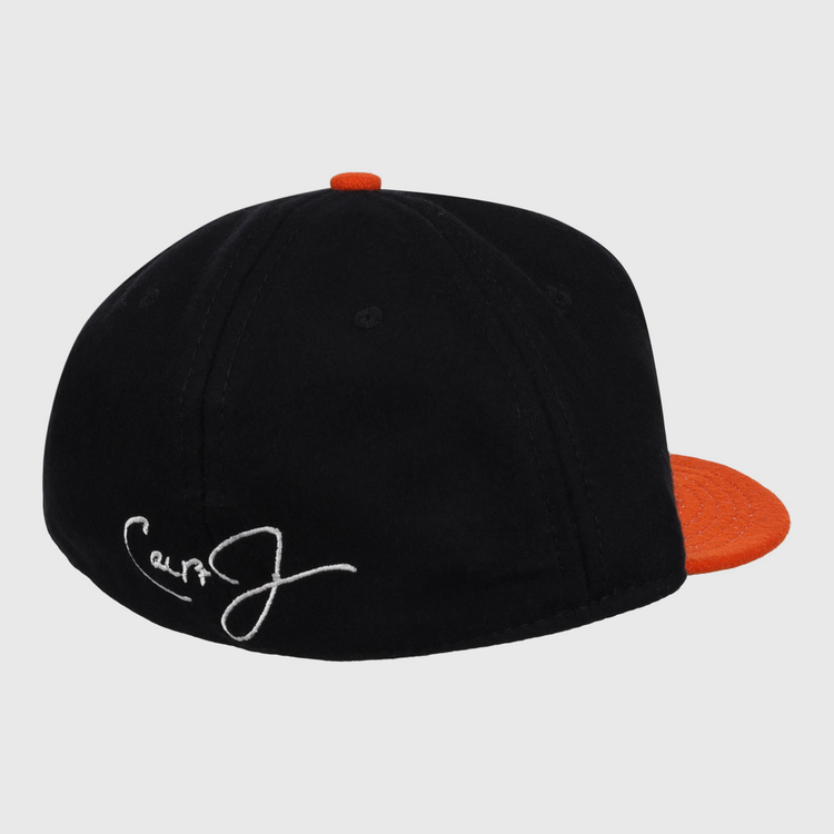 The Ebbets Field Flannels Cal Ripken Jr. Signature Series Ballcap is a black vintage wool cap with an orange brim and button, plus a white embroidered signature on the back—a tribute to Cal Ripken Jr. and the National Baseball Hall of Fame.