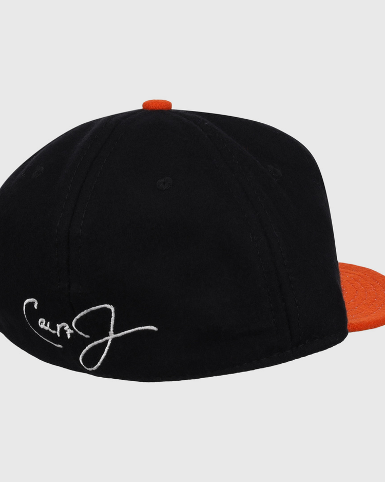 The Ebbets Field Flannels Cal Ripken Jr. Signature Series Ballcap is a black vintage wool cap with an orange brim and button, plus a white embroidered signature on the back—a tribute to Cal Ripken Jr. and the National Baseball Hall of Fame.