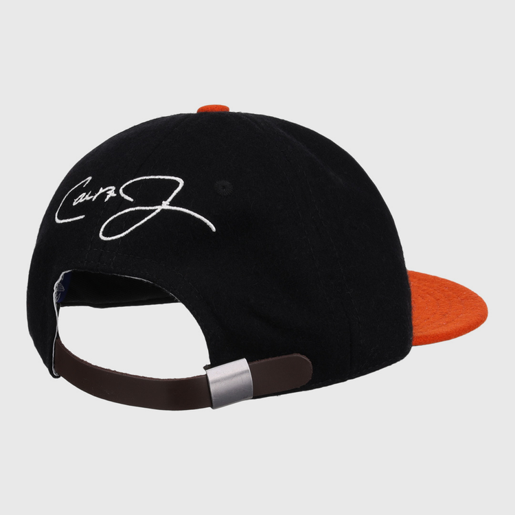The Ebbets Field Flannels Cal Ripken Jr. Signature Series Ballcap features a vintage black and orange wool design, brown adjustable strap, and a white embroidered signature on the back panel.