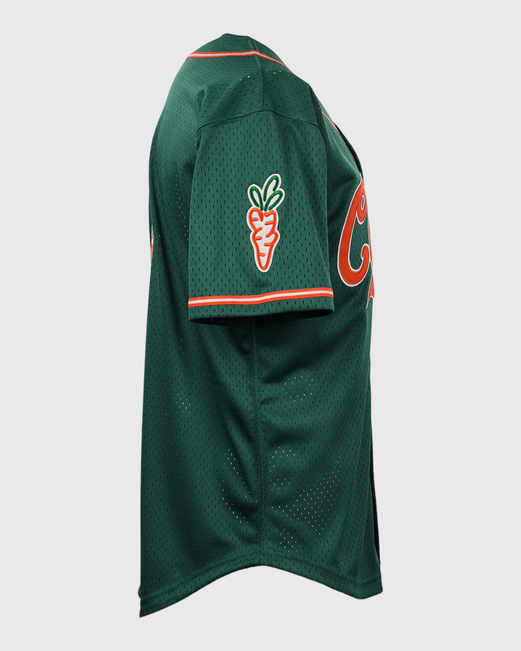 The EFF Carrots Arlington Heights Collection Button-Up Mesh Jersey in green mesh with orange trim features a carrot patch on the sleeve and partial orange front lettering, shown from a side view. Made in collaboration with Carrots and Ebbets Field Flannels.