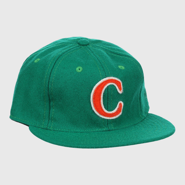 The Carrots Arlington Heights Collection “C Ballcap by Ebbets Field Flannels is a green, vintage-style wool cap with a curved brim and an orange and white embroidered “C” on the front.