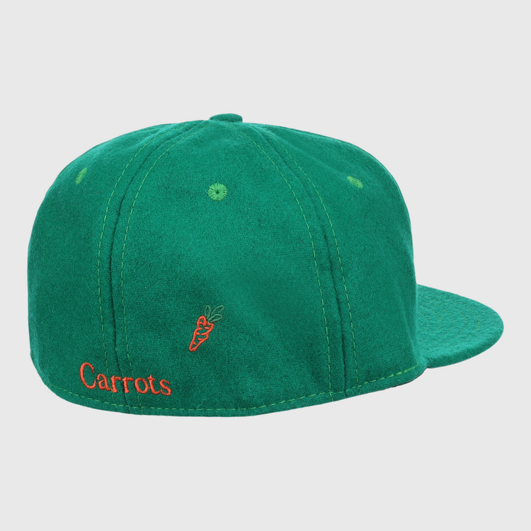 The Carrots Arlington Heights Collection “C Ballcap by Ebbets Field Flannels is a green suede baseball cap, shown from the back with orange Carrots embroidery and a small carrot graphic.