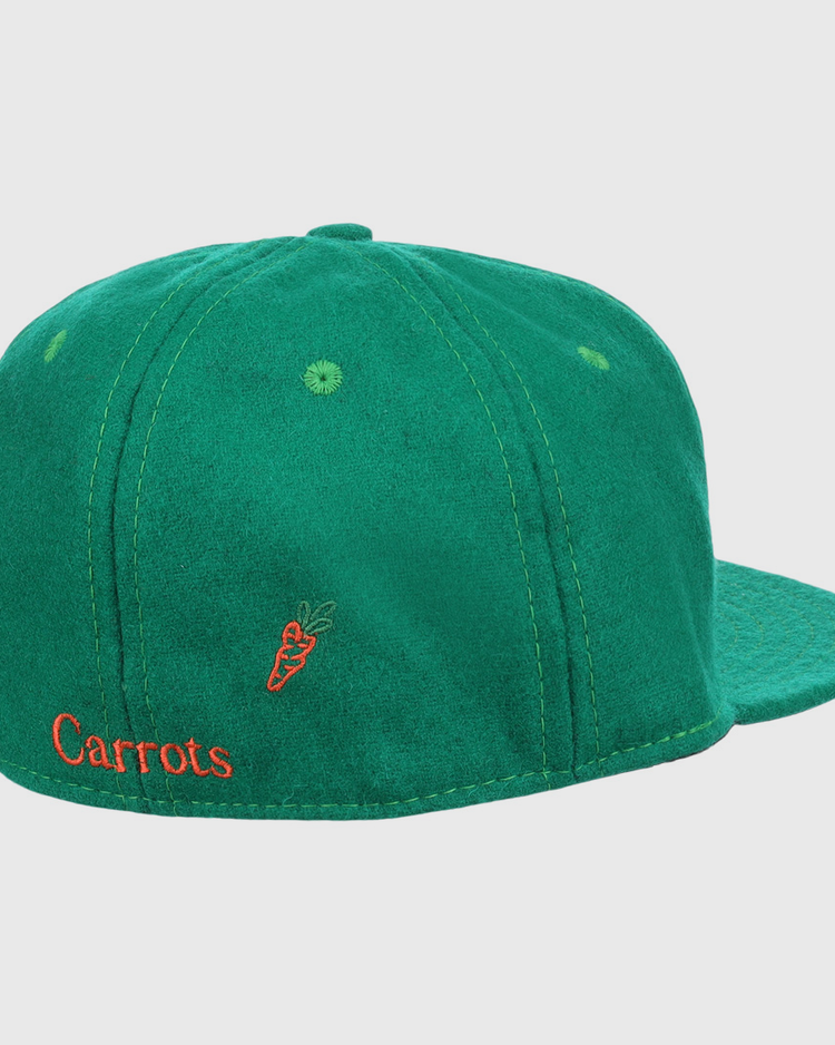 The Carrots Arlington Heights Collection “C Ballcap by Ebbets Field Flannels is a green suede baseball cap, shown from the back with orange Carrots embroidery and a small carrot graphic.