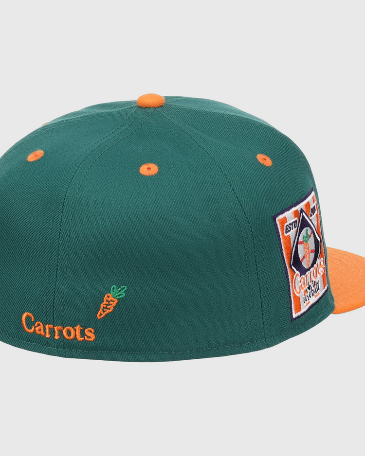 The EFF Carrots Arlington Heights Collection Logo Fitted Ballcap is green with orange accents, an orange button and brim, star side patch, and Carrots text plus carrot graphic on the back. Part of the Carrots Ebbets Field Flannels collection.